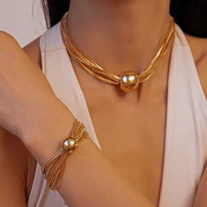 Multi-layer gold choker necklace and bracelet set with polished spherical metal pendant