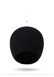 Detail view of the black knit beanie showing the vertical ribbed texture and logo plaque