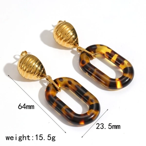 Detailed view of 18K gold earrings with tortoise resin showing size 64mm and 23.5mm