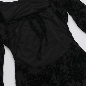 Close-up of black floral burnout fabric featuring an elegant back tie-up detail