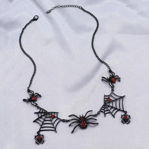 Gothic black spider and web necklace with red gems on elegant silk background