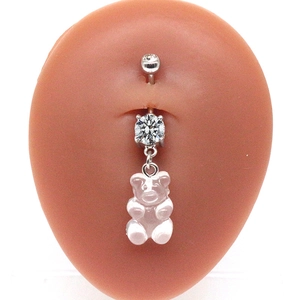 Detail of belly button ring featuring pink resin bear pendant and zircon stones