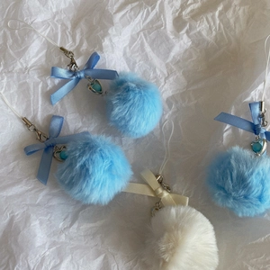 Cute pom-pom keychains with satin bows and heart beads in blue and white plush