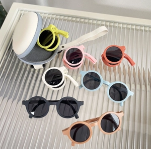Foldable macaron round sunglasses for kids in various colors with a portable zip case