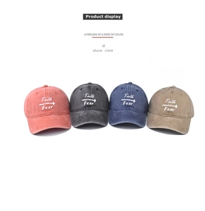 Detail showing four washed cotton baseball caps with Faith Over Fear embroidery in 4 colors