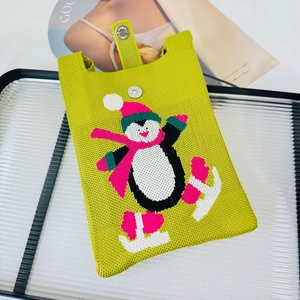 Close-up of grass green knitted penguin mini crossbody bag with metal magnetic closure