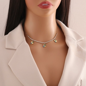 Detailed view of evil eye clover necklace with small rhinestones on a female mannequin neck