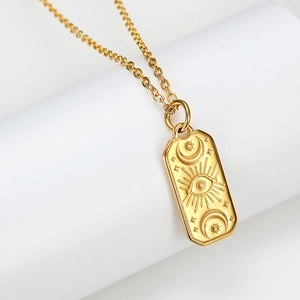 Vintage gold rectangle pendant necklace with embossed celestial eye moon and stars motifs
