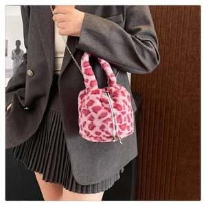 Detail of pink leopard plush bucket bag with drawstring closure and silver chain strap