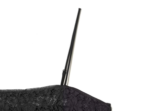 Close-up of black lace top featuring delicate spaghetti straps and intricate floral details