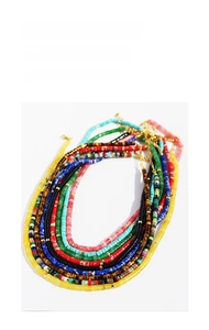 Detailed top view of colorful bohemian beaded necklaces with lapis and tiger eye stones