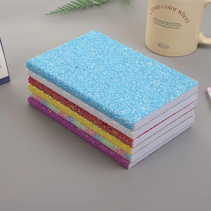 Set of colorful sparkling sequin notebooks in blue, red, and purple for students