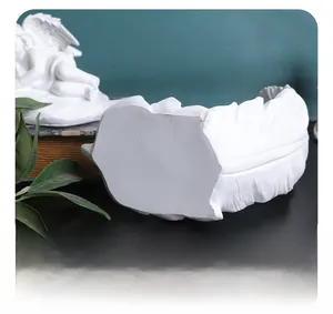 Detailed close-up of the stable flat base on the white resin angel wing sculpture