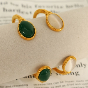 18k gold plated stainless steel open bangle with oval cat eye stones in green and white