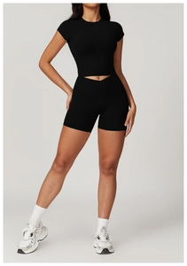 Close-up of black recycled yoga set featuring high-waist shorts and cropped short-sleeve top