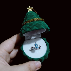 Blue teardrop gem ring in a green Christmas tree shaped velvet jewelry gift box