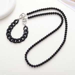 Detail of black acrylic bead phone chain with chunky plastic links and metal lobster clasps