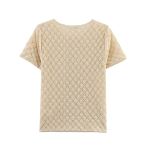 Detailed view of the diamond honeycomb hollow-out knit texture on this beige short sleeve top
