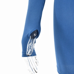 Detail of blue ribbed knit top featuring functional thumbhole cuffs on a clear mannequin