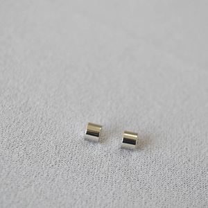 Macro shot of two cylindrical silver metal spacer beads for DIY jewelry making