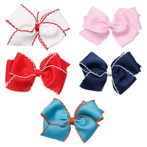 Detailed set of five ribbed ribbon bow hair clips with contrasting wavy trim for girls