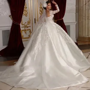 Luxurious white long sleeve bridal gown with lace embroidery and large satin train