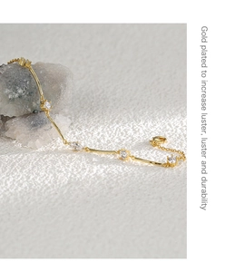 Detail of gold-plated bracelet with marquise zircon stones and a secure lobster clasp
