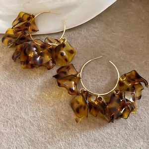 Retro leopard print petal hoop earrings in amber resin with gold metal circle detail