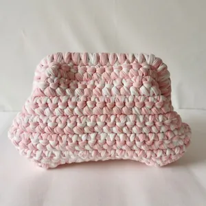 Detail of pink and white handmade crochet cloud bag showing woven cotton rope texture