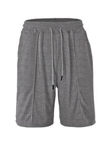 Detail of grey men's casual shorts showing textured geometric jacquard fabric and drawstring