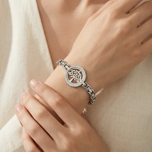 Close-up of silver Tree of Life bracelet with pavé diamonds on a female wrist