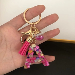 Pink resin alphabet A keychain with glittering sequins and a stylish tassel charm