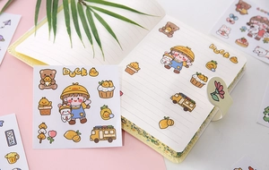 Detailed view of cute cartoon PVC stickers on a notebook featuring bears and school bus