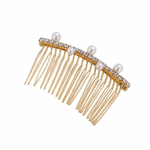 Elegant gold metal hair comb with white pearls and sparkling crystals on white background
