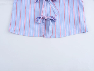 Detailed view of striped shirt hem featuring a minimalist bow tie design and clean stitching