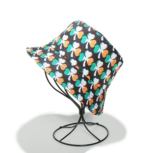 Detail of St. Patrick's Day bucket hat with green clover shamrock print on canvas fabric