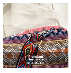 Close-up of colorful Bohemian woven texture with vibrant patterns and gold hardware