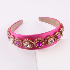 Detail of rose pink satin headband featuring colorful rhinestones and crystal settings