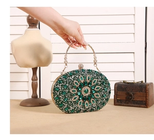 Detail of green sunflower evening clutch bag featuring sparkling crystals and gold handle