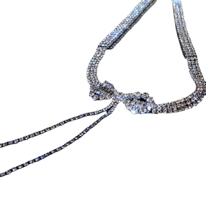 Elegant silver bow pendant necklace with sparkling rhinestone fringe and layered tassels
