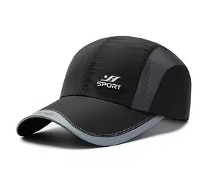 Detail of breathable grey mesh fabric and white SPORT logo on black quick-dry cap