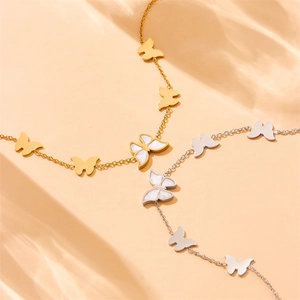 Detailed close-up of gold and silver butterfly chain bracelets with pearl shell inlays