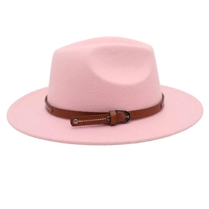 Close-up of pink felt fedora hat featuring a brown leather belt buckle and wide brim