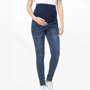Detail of high waist maternity jeans with elastic belly support panel in dark blue denim
