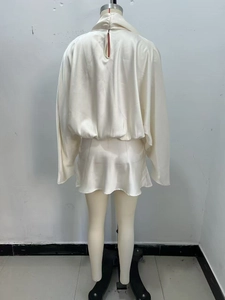 Close-up of cream white satin mini dress featuring a high collar and back zipper detail