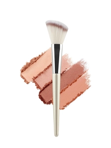 Detail of angled champagne makeup brush head with soft synthetic bristles and powder strokes