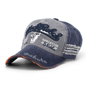 Detail of vintage washed baseball cap featuring BlackRebel embroidery and frayed brim edge