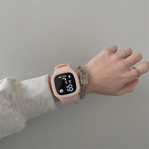 Pink digital LED sports watch with silicone strap showing time and date on wrist