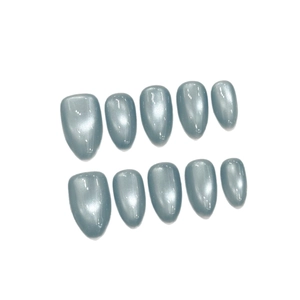 Blue cat eye press-on nails in almond shape with sparkling silver magnetic effect