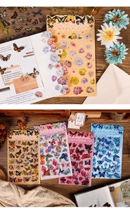 Detailed vintage butterfly and flower stickers set for scrapbooking on wooden background